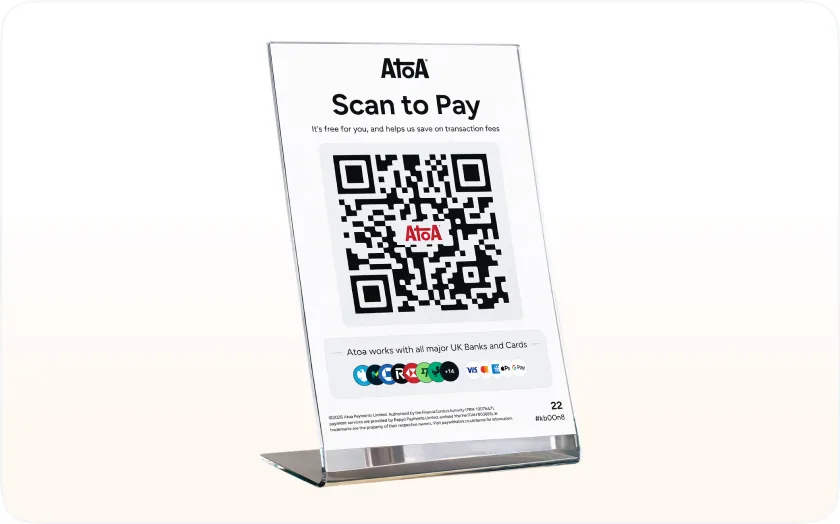 Atoa Scan to Pay QR code stand on a shop counter, showing the major UK bank and card logos it works with